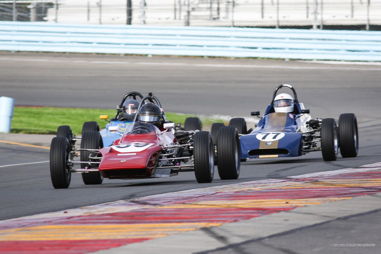 A couple of race cars on a race trackDescription automatically generated